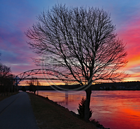 Sun rise colors moving tide Bourne Bridge