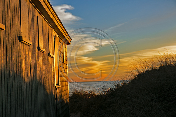Sun set at wooden shack Buzzards Bay