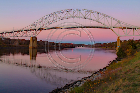 Sagamore Bridge with beautiful pink skies at sunrise.  Cape Cod Canal.