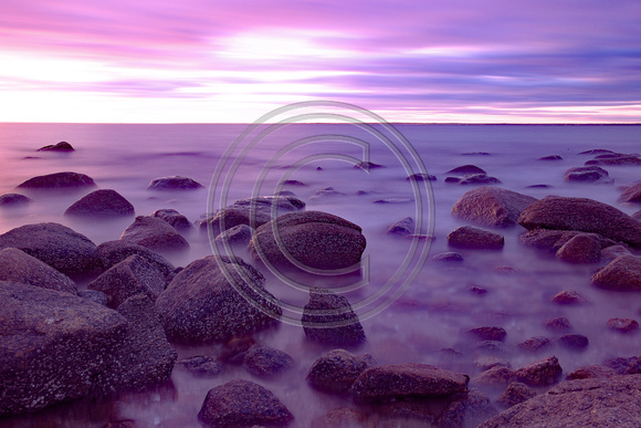 Purple skies at sunset on the rocks Buzzards Bay Cape Cod