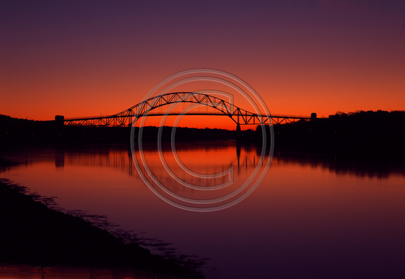 Golden view of sunrise reflections Sagamore Bridge
