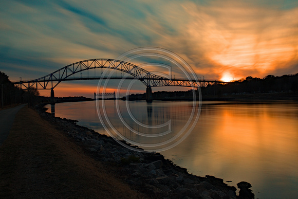 Sun setting blue gold Bourne Bridge