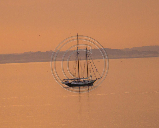 Sunrise with sailboat Cape Cod Bay