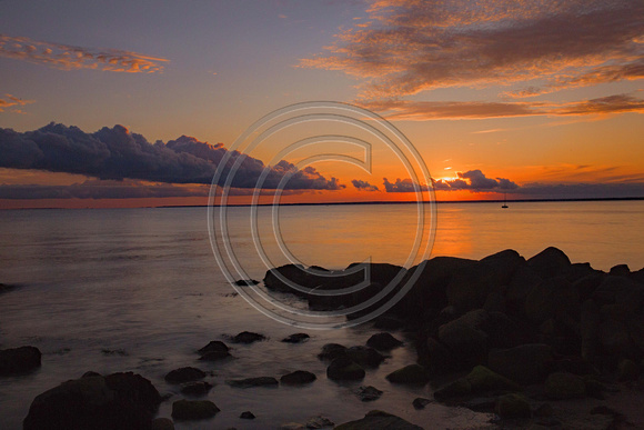 Stunning sunrise with rocks and beach Cape Cod Ba